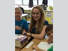 Meghan Miller helps 4th graders with their reading skills at Palm City Elementary.
